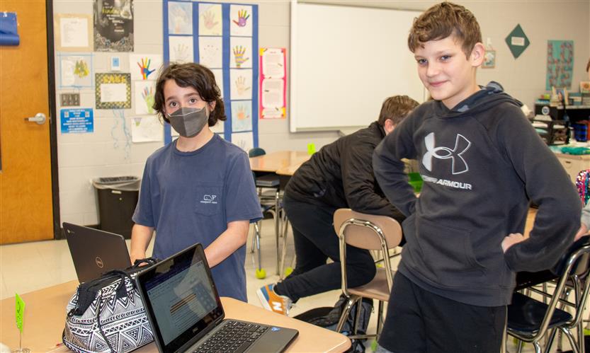 Two sixth grade boys stand up during class